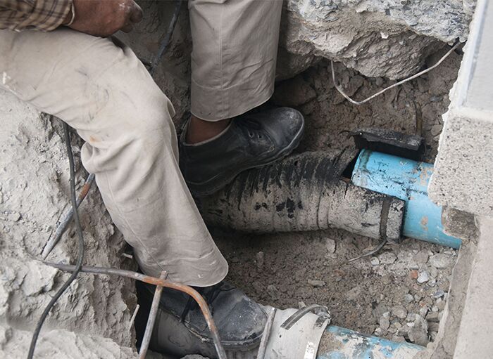 drainage-repair (optimised) Drainage pipe being fitted under a driveway