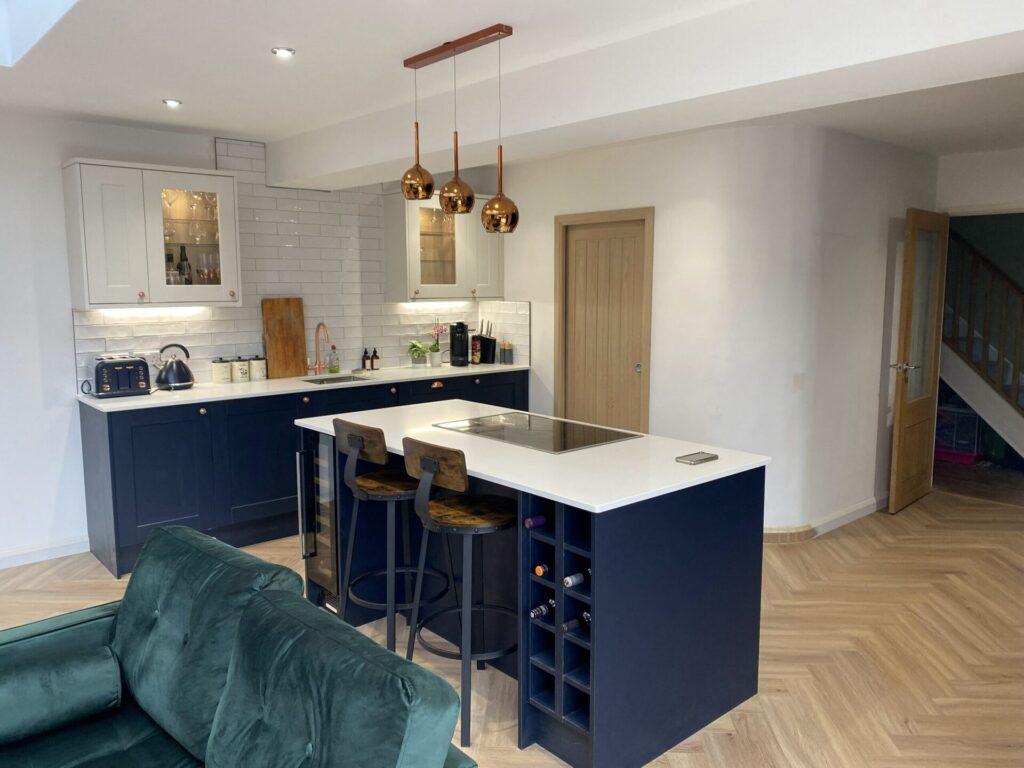 Navy kitchen island with copper pendant lights