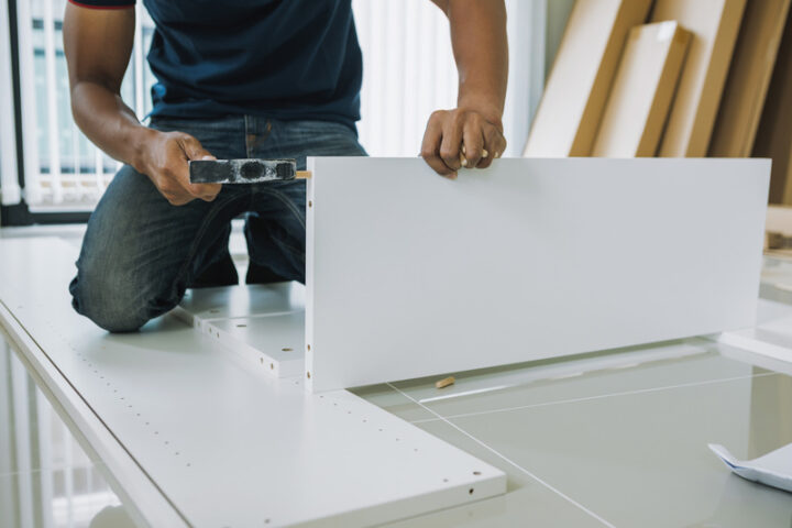 Service man assembling furniture for customer, Delivery service furniture store and assembling for buyer. furniture assembly